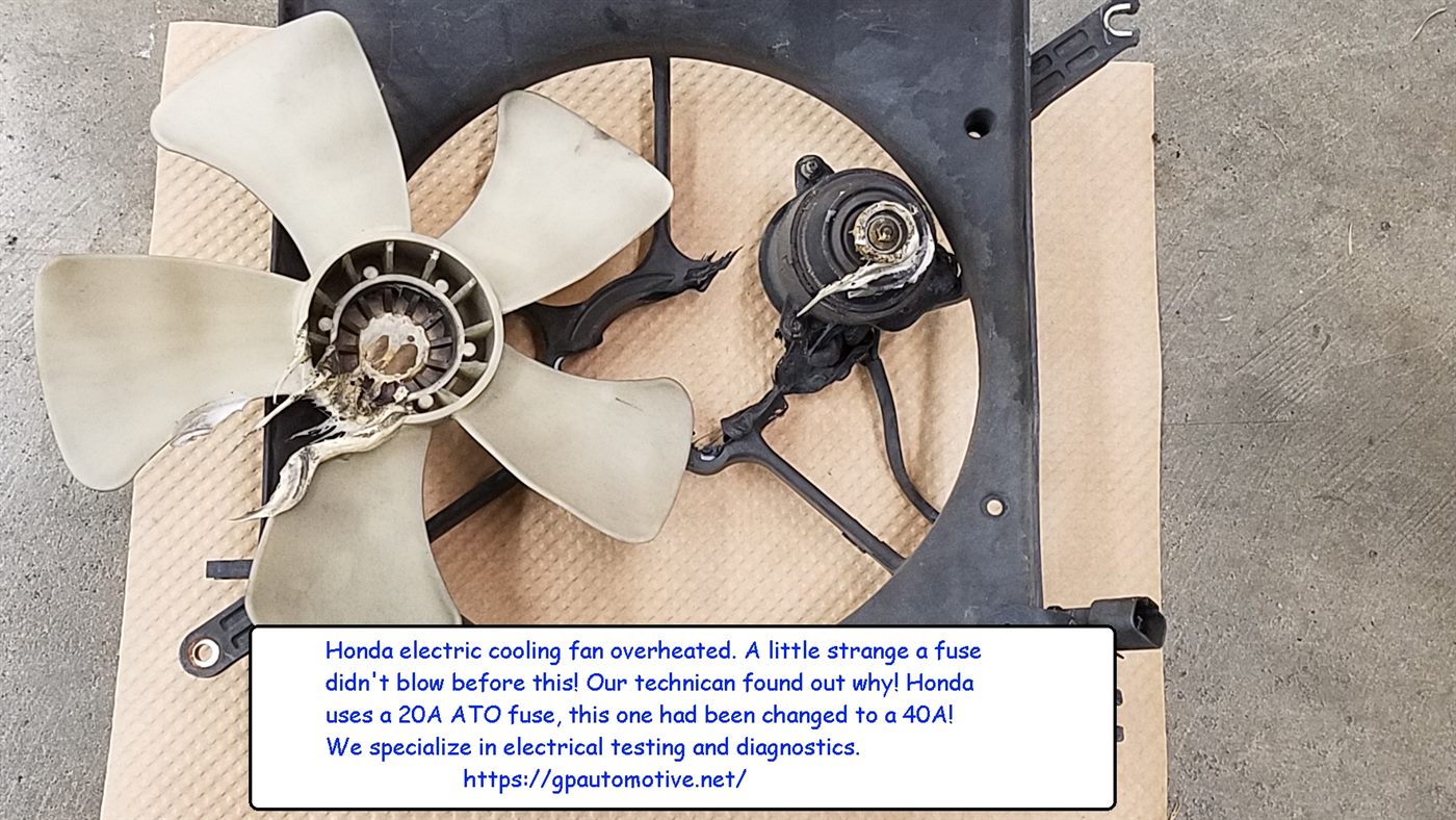 An electric cooling fan on our bench, its hub melted from overheating, with our note about the 40-amp fuse that should have been a 20